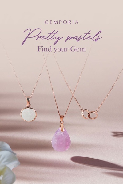 A high-end, minimalist advertisement featuring three elegant gold and gemstone necklaces against a soft, monochromatic pastel background.