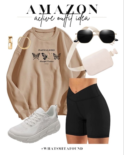 A clean, organized flat-lay display featuring a sweatshirt, biker shorts, and accessories on a neutral background to inspire a complete look.