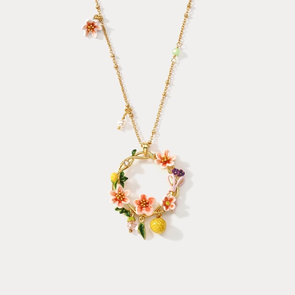 A high-quality, centered product shot of a gold necklace featuring delicate floral charms against a clean, neutral background.