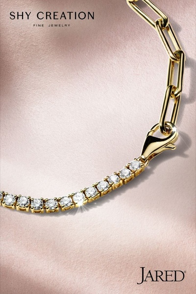 A close-up, studio-quality image of a delicate diamond-studded gold bracelet, focusing on the refined craftsmanship and clean, soft lighting.