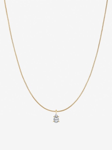 A high-end studio capture of a gold chain featuring a single delicate pear-shaped pendant on a clean off-white background.