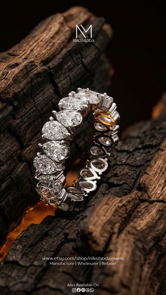 A close-up photograph of a luxury diamond ring featuring multiple pear-cut stones, set against a dark, rustic charred wood background to emphasize high-end contrast.
