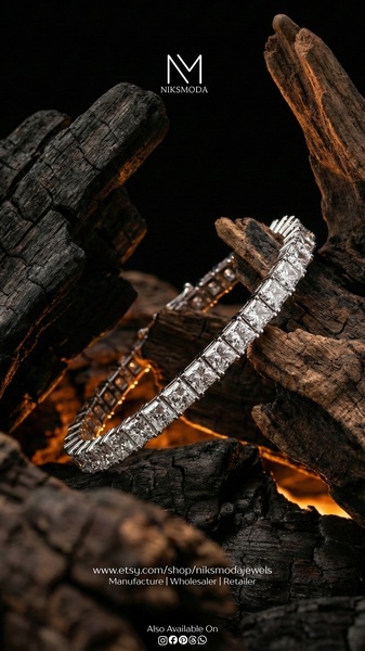 A high-end tennis bracelet is showcased resting against charred wood, utilizing high-contrast lighting to emphasize texture and luxury.