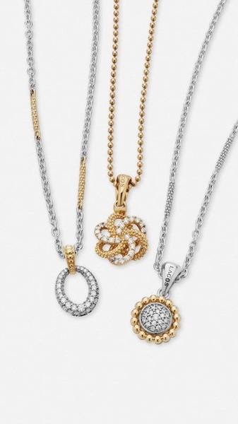 A high-contrast, clean product hero shot featuring three distinct gold and silver necklaces displayed against a bright, neutral background.