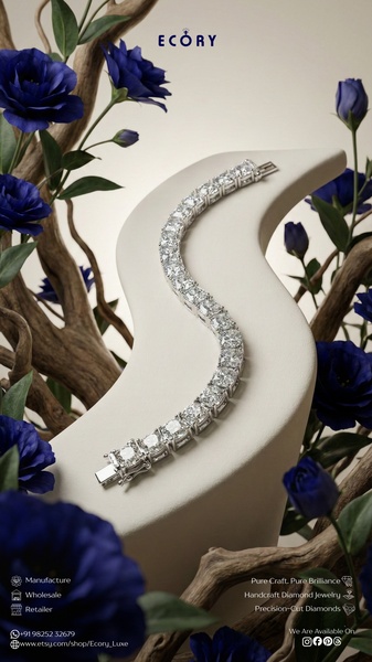 A luxury-focused still life shot of a diamond bracelet draped on a white display against a backdrop of blue flowers and wood branches.