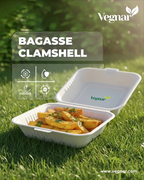 A high-quality 4:5 image showing a sustainable clamshell container holding potato wedges in an outdoor grass setting.