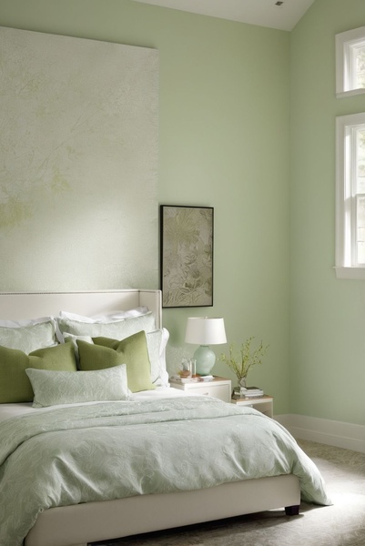 A high-end bedroom scene featuring a minimalist bed set in soft greens, designed to evoke tranquility and premium comfort.
