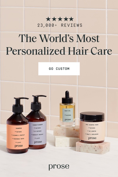 A clean, studio-lit photograph featuring a full set of personalized hair care bottles and jars against a soft tile background.