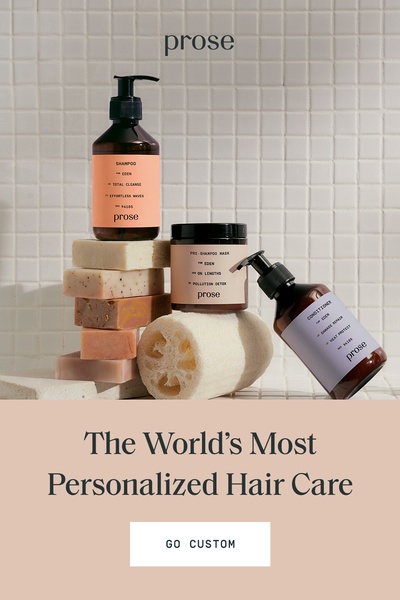 A clean, studio-lit photograph of personalized hair care bottles and bars arranged on a tiled surface to communicate custom product offerings.