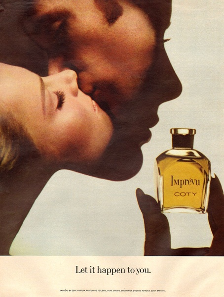 A close-up, high-contrast vintage-style photograph featuring a couple in an intimate embrace beside a bottle of Imprivu perfume.