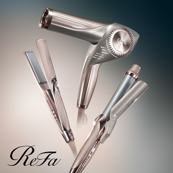 A high-end, studio-lit display of a hair dryer, straightener, and curler set against a soft gradient background to emphasize premium design.