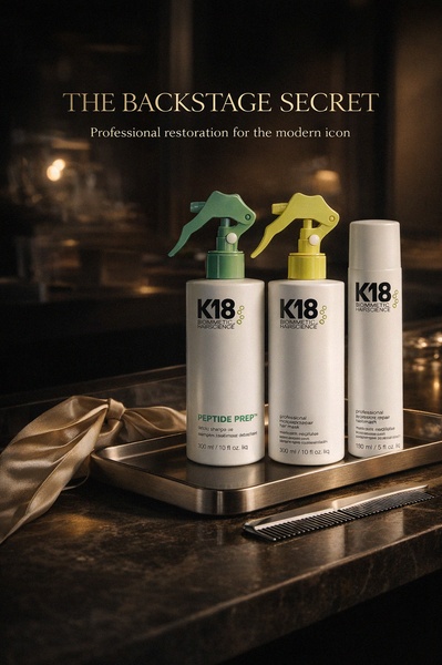 A sophisticated, high-end product shoot showcasing a three-piece professional hair care set on a metallic tray in a moodily lit environment.