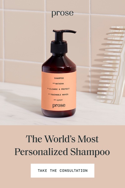 A clean, high-contrast shot of a custom-labeled shampoo bottle on a marble countertop, emphasizing a personalized, premium brand experience.