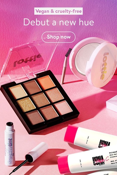 A high-saturation, 2:3 vertical product hero image featuring an eyeshadow palette and makeup essentials in a monochromatic pink lighting environment.