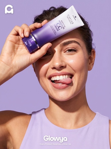 A close-up portrait of a model holding a hair care tube, utilizing a monochromatic purple color palette to create a high-contrast, clean aesthetic.