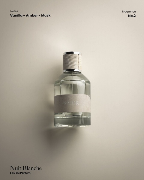 A high-end, minimalist studio shot of a perfume bottle against a soft neutral background, highlighting the fragrance notes.