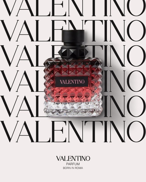 This creative showcases a perfume bottle centered on a repeating brand name background with a clean, high-contrast aesthetic.