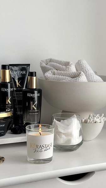 A high-end lifestyle composition featuring premium hair care bottles and accessories, shot with clean lighting and neutral tones.