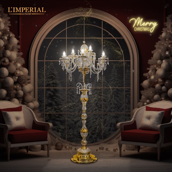 A high-end, square-format advertisement featuring a crystal chandelier in a festive, decorated living space during winter.
