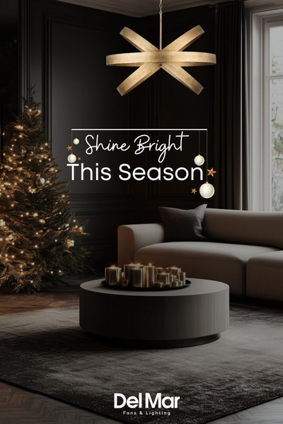 A sophisticated, moody living room scene featuring a gold chandelier above a coffee table, decorated with holiday accents to evoke a warm, festive feeling.