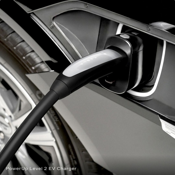A high-detail, close-up shot of an EV charger plugged into a vehicle, highlighting the build quality and seamless connection.