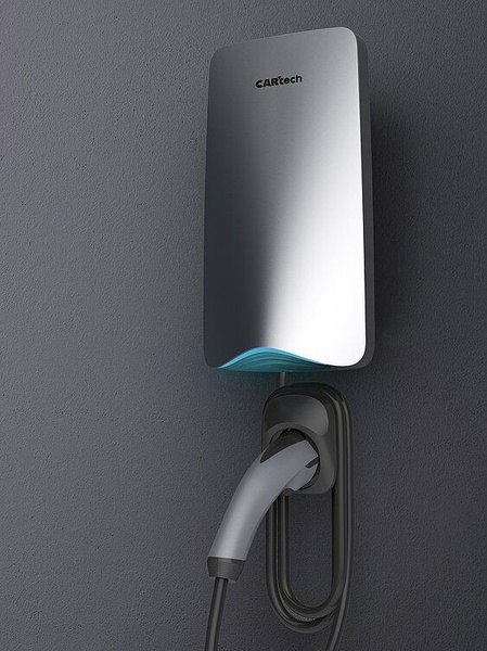 A high-quality, studio-lit photograph of a modern wall-mounted EV charger displayed on a textured grey background.