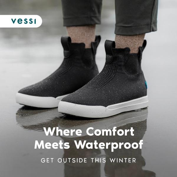 A 1:1 square creative featuring dark, waterproof sneakers in a wet, rainy environment to establish seasonal utility and comfort.
