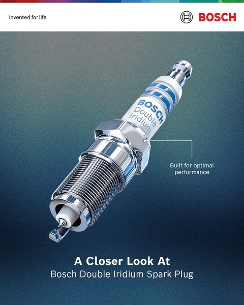 A clean, high-contrast studio shot of a spark plug with a callout box highlighting its performance benefits against a dark professional background.