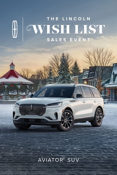 A high-end luxury vehicle advertisement featuring the Aviator SUV set against a snowy, holiday-themed winter town square.