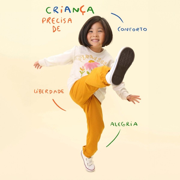 A minimalist, high-contrast 1:1 square ad for a children's sweatshirt, featuring a joyful child in motion with clear, value-based brand messaging.