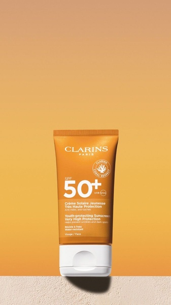 sunscreen, sun protection, spf cream, facial sunscreen, sunblock, uv protection, sun care, product launch, minimalist, warm, trustworthy, orange