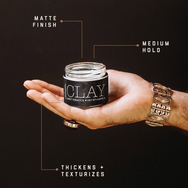 A high-contrast, professional product shot of hair styling clay that uses simple lines and text callouts to highlight performance benefits.
