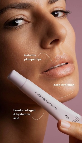 A high-conversion close-up of a model applying lip balm, featuring clear text callouts pointing to the product benefits.