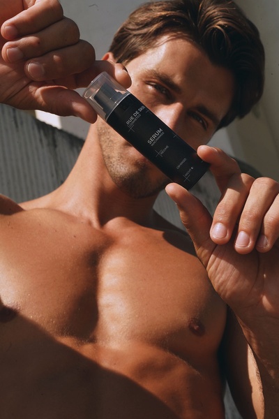 face serum, facial serum, skincare serum, anti-aging serum, men's skincare, grooming serum, skin treatment, product launch, lifestyle, luxurious, warm, brown, neutral