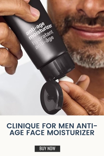 A close-up shot of a man's hand applying a white anti-age moisturizer cream from a black tube, focusing on product texture and clarity.