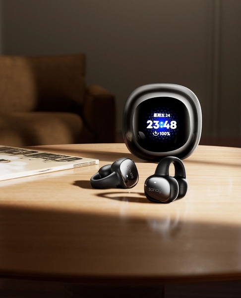 A clean, high-contrast studio shot of wireless earbuds resting on a wooden table, next to a modern smart clock display.