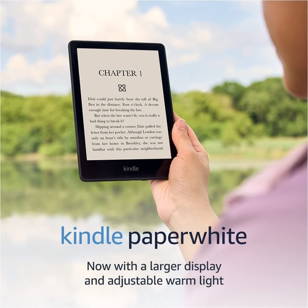A close-up shot of an eReader held in a natural outdoor setting, focusing on the screen readability and key hardware upgrades.