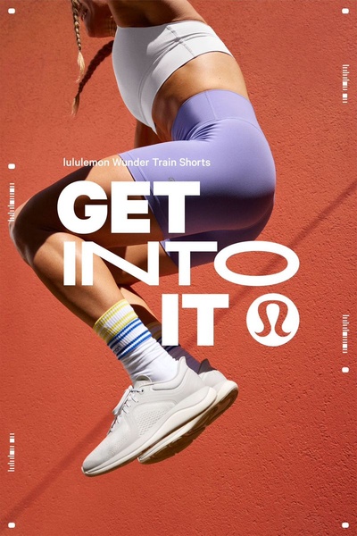 Vertical activewear ad with purple training shorts in mid-air against a deep red wall in a high-contrast studio shot