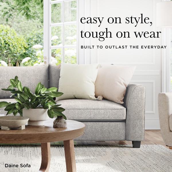A 1:1 ratio lifestyle advertisement featuring a gray sofa in a brightly lit room with a coffee table and houseplant.