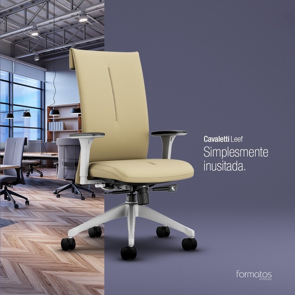 A high-end office chair presented against a split-screen background, showing a professional office environment on the left and a solid color block on the right.