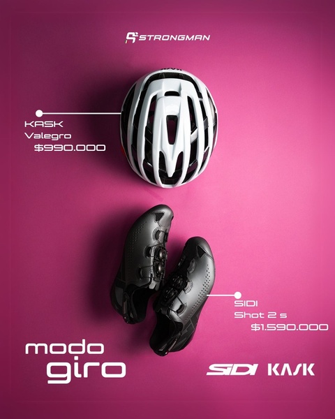 A clean, studio-lit flat lay presentation of a high-performance bicycle helmet and professional cycling shoes against a vibrant magenta background.