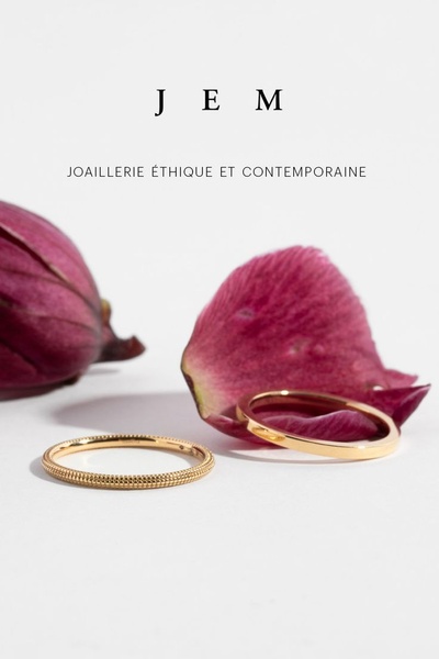 This creative showcases two gold rings placed elegantly beside organic floral elements against a clean, neutral background.