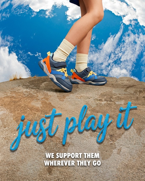 This creative showcases kids' footwear against a dramatic sky background, emphasizing freedom and durability through an adventurous, outdoorsy visual theme.