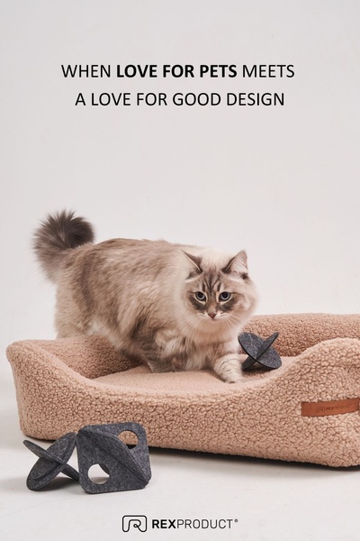 A high-end, clean studio shot of a fluffy pet bed and matching toys, featuring an aspirational headline centered on design and affection.