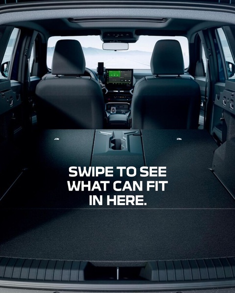 A high-contrast rear view of a car trunk showing an empty cargo area with a direct invitation to interact and explore storage potential.