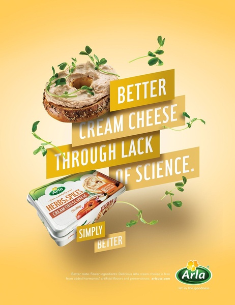 A minimalist, visually striking advertisement for cream cheese spread featuring bold typography and floating fresh herb imagery against a soft yellow background.