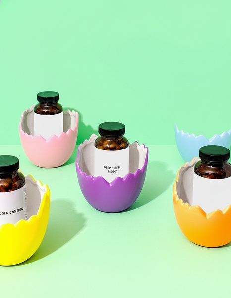 This creative showcases multiple sleep supplement bottles nestled inside brightly colored, broken egg shells against a matching pastel green background.