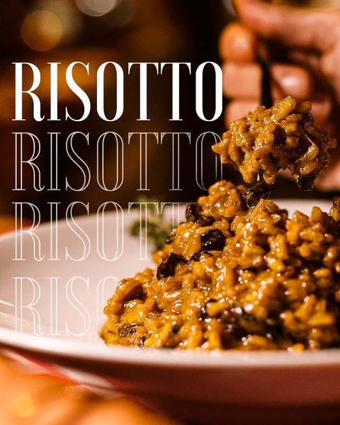 A visually driven advertisement for risotto using a high-contrast close-up shot and repeated typography to emphasize texture and appetite appeal.