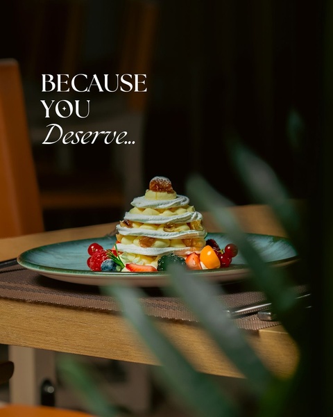 A high-end, minimalist presentation of a multi-layered cream and fruit dessert, using soft, moody lighting to evoke a feeling of premium indulgence.