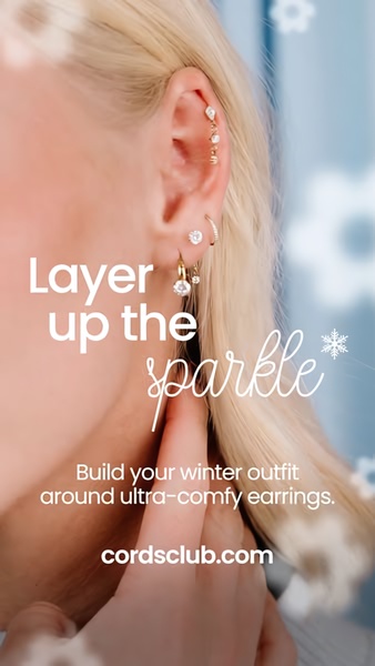 A close-up aesthetic shot of an ear with multiple earrings, highlighting a seasonal winter theme with subtle snowflakes.